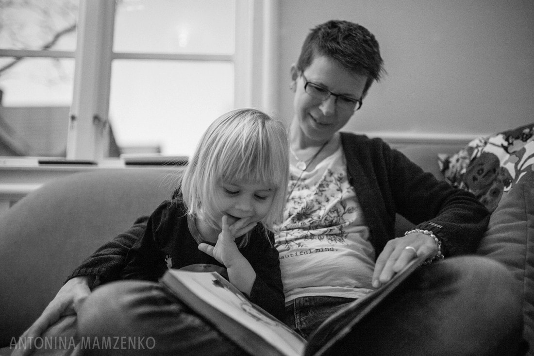 mom and young boy reading a thomas the tank engine book together