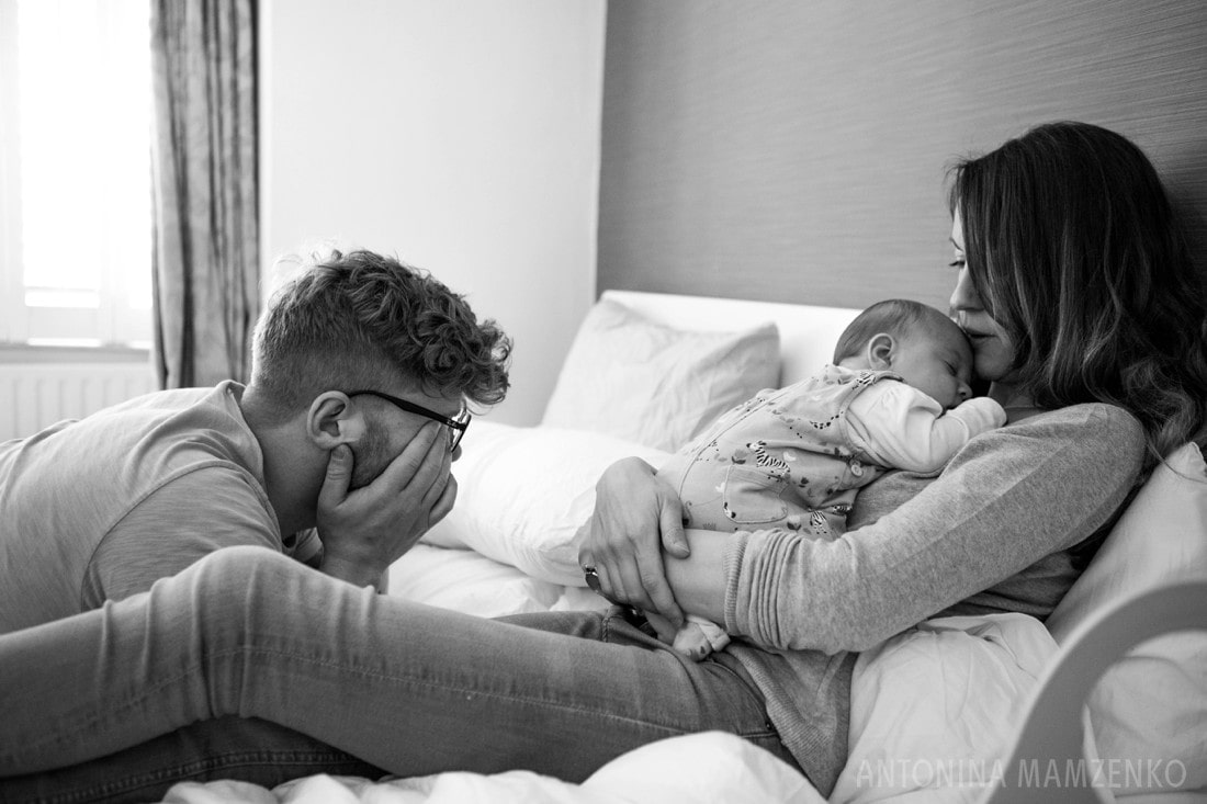 tired first time parents with their newborn baby