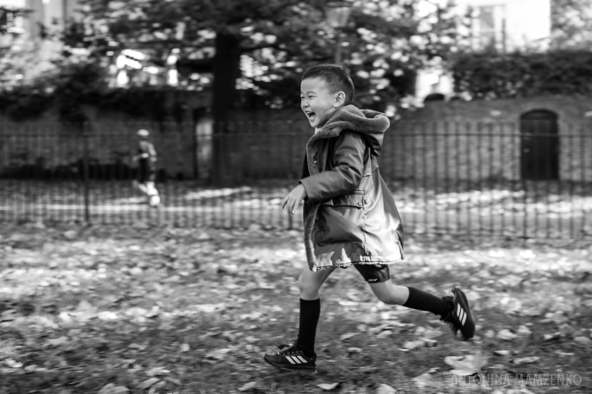 boy running though holland park