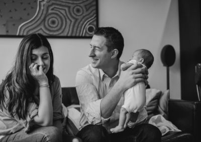 new parents holding a newborn baby in teddington london